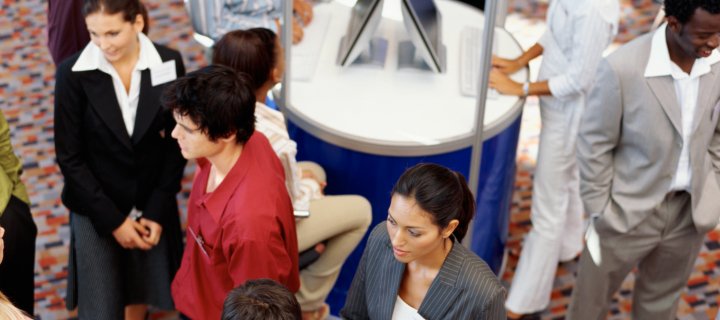 People walking around an exhibit hall